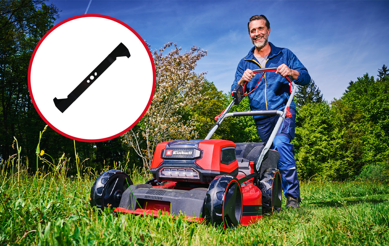 Close-up of an Einhell lawn mower in the garden, with focus on the spare blade