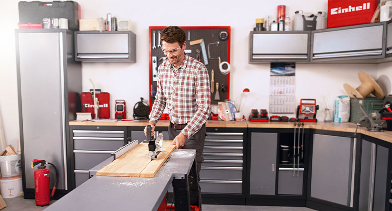man sawing in workshop